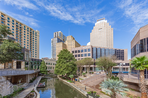 San Antonio, USA - October 31, 2023:   Famous Riverwalk in San Antonio iwith view to skyline in midday sun.