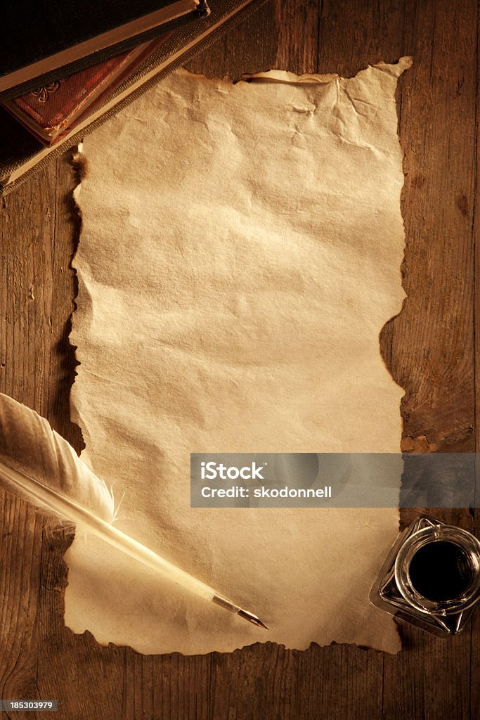 Antique Paper on a Wooden Desk This is an overhead photo of a old blank sheet of paper surrounded by a bottle of ink and a quill pen. There is a lot of space for copy.Click on the links below to view lightboxes. Paper Scroll Stock Photo