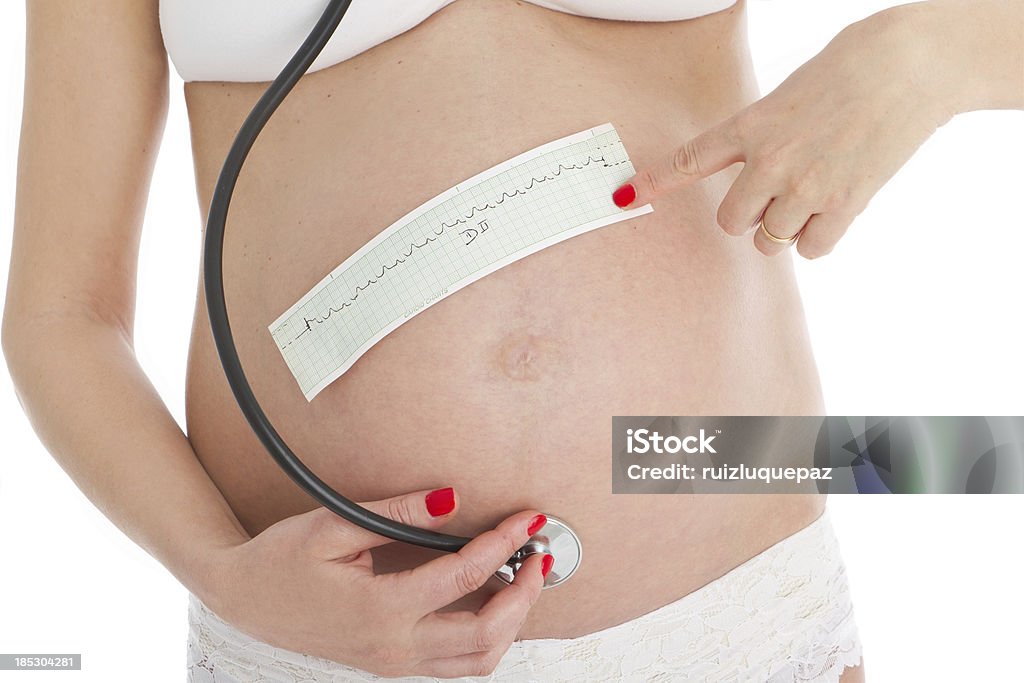 Pregnancy and medicine Pregnant woman with cardio charts and stethoscope Abdomen Stock Photo