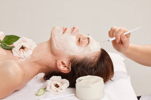 istock Professional face care brush for cosmetic procedures that evenly distributes the cream for the face of a girl at a beautician's appointment. Care cosmetics 1853043370