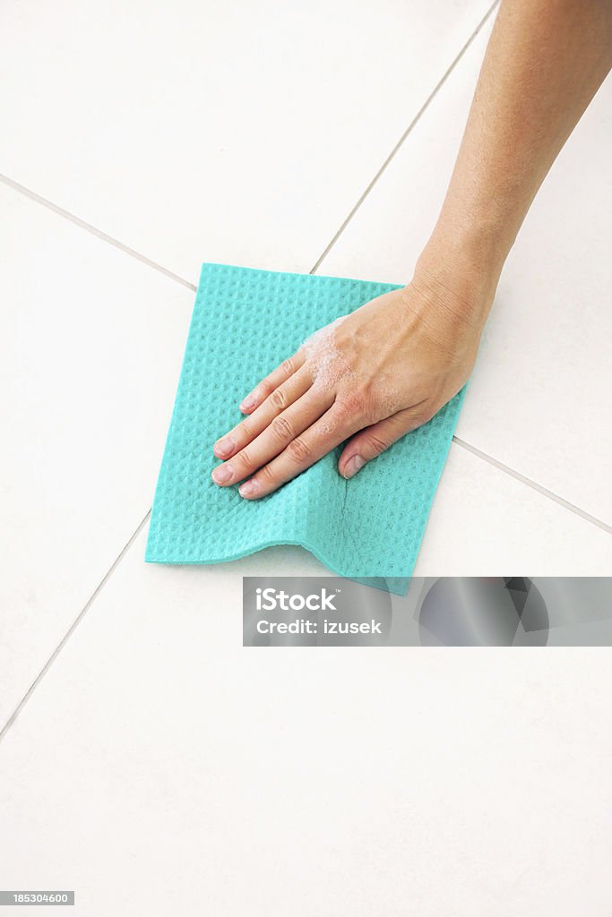 Cleaning tile Close-up on human hand cleaning tiled floor using cleaning rag. Cleaning Stock Photo