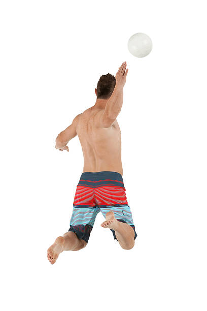 istock Rear view of a man playing beach volleyball 185304720