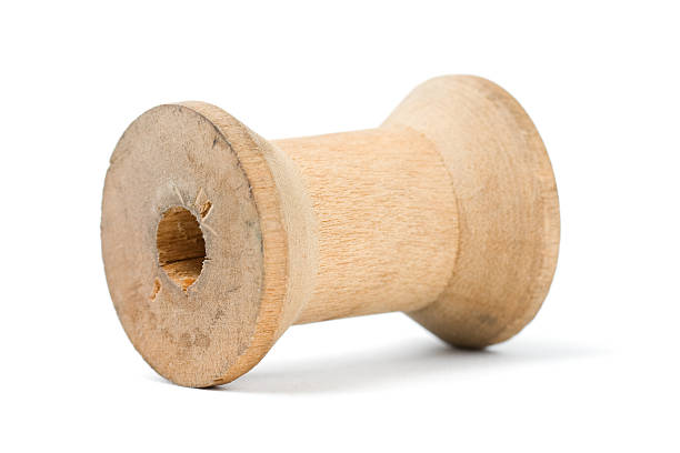 Wooden Spool An empty wooden thread spool.  wooden spool stock pictures, royalty-free photos & images