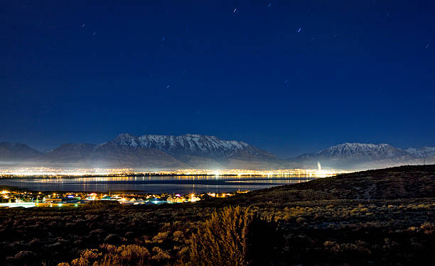 Utah County at Night "A view of Utah Lake and County (Lehi, American Fork, etc) and the Wasatch Mountains. Taken from Saratoga SPrings, around 10pm at night with long exposure for small star trails." lake utah stock pictures, royalty-free photos & images
