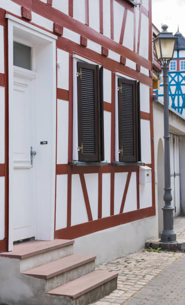 istock Window and brown door on old traditional house 1853054828