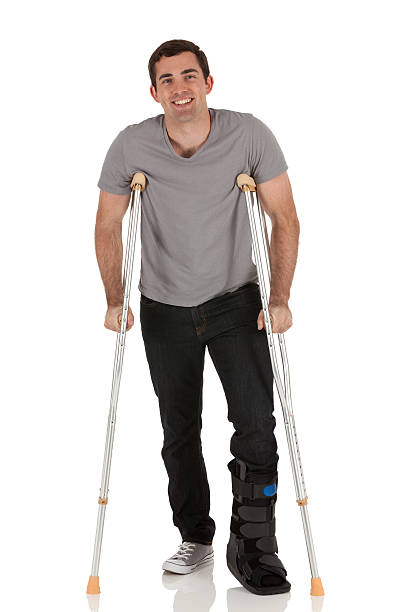 istock Injured man walkiing with the help of crutches 185305511
