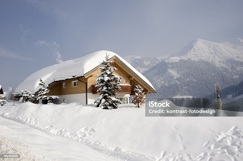 Typical wooden house, Kleinwalsertal, Mittelberg, Austria "Typical wooden house in a snowcovered landscape. Located in Mittelberg, Kleinwalsertal in Austria. There are some snowflakes visible." Kleinwalsertal Stock Photo