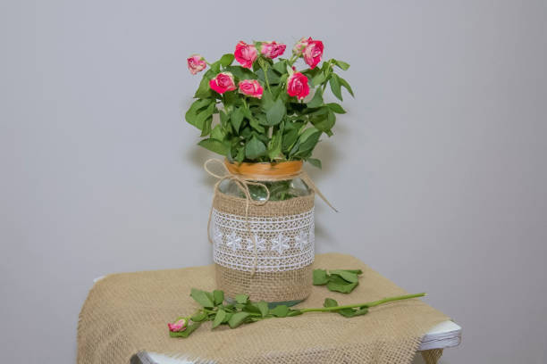 istock Bouquet of red roses in a vase on a table 1853059688