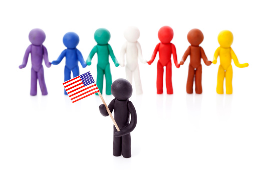 Person hold USA flag on forehead of Group of Peoples isolated on white