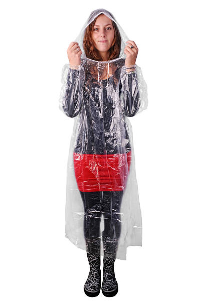 Girl in translucent plastic rain coat isolated on white stock photo