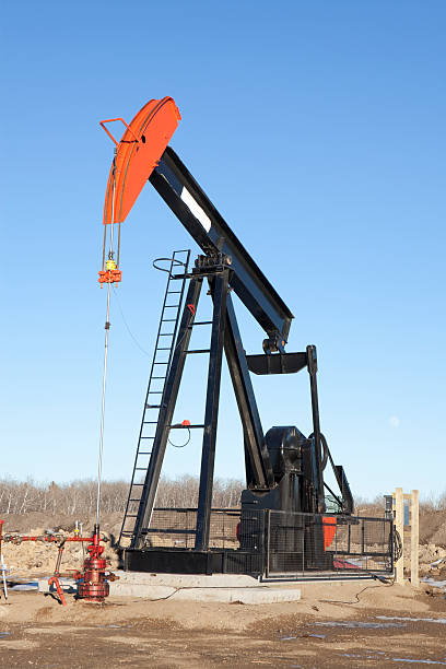 Local Oil Local Oil, The hunt is on in Manitoba for Oil. This Image was taken close to the Saskatchewan border in Manitoba, north west of the town of Virden. oil pump petroleum equipment development stock pictures, royalty-free photos & images