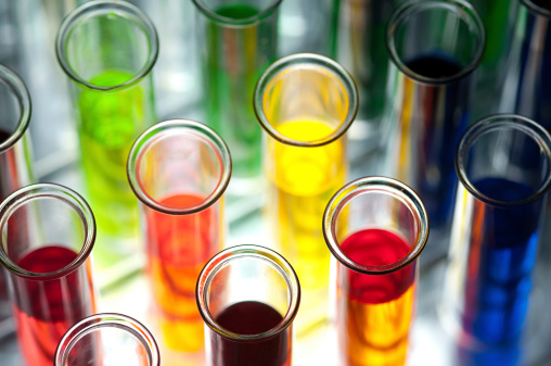 Laboratory glassware with different liquid samples, focus on beaker