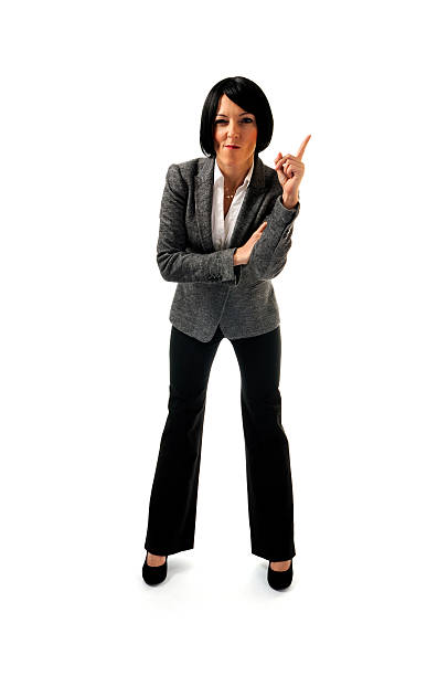 Businesswoman pointing right on white background stock photo