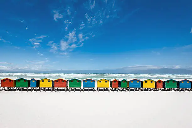 "Beautiful colorful painted beach huts on perfect white sandy beach of Muizenberg, Cape Town, South Africa, Africa"