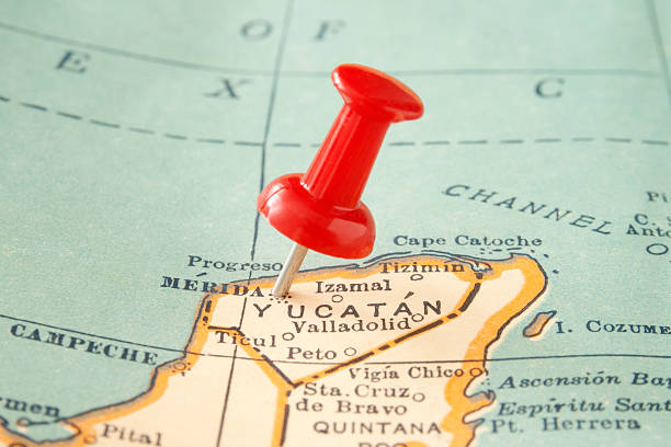 Merida Red pushpin pointing to Merida city in more than fifty years old map yucatan stock pictures, royalty-free photos & images