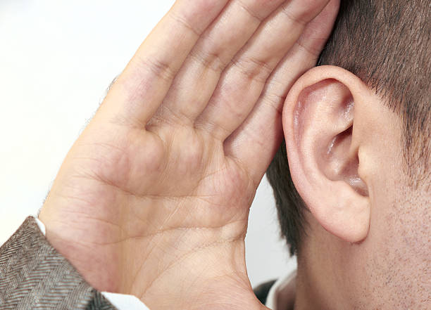 istock A man puts his hand close to his ear 185307436