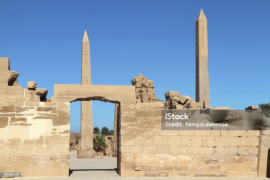 Cachette Court and Obelisks, Great Temple of Amun, Karnak, Egypt "View northward from Cachette Court towards the obelisks of   Tuthmosis I (Left) and Hatshepsut (right).  Covering an area of 100 hectares, Karnak is the largest temple complex ever built." Amon Stock Photo