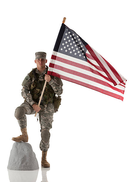 Army soldier standing with an american flag