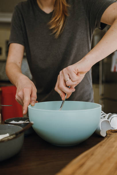 istock Women's hands mixing ingredients in bowl. 1853082958