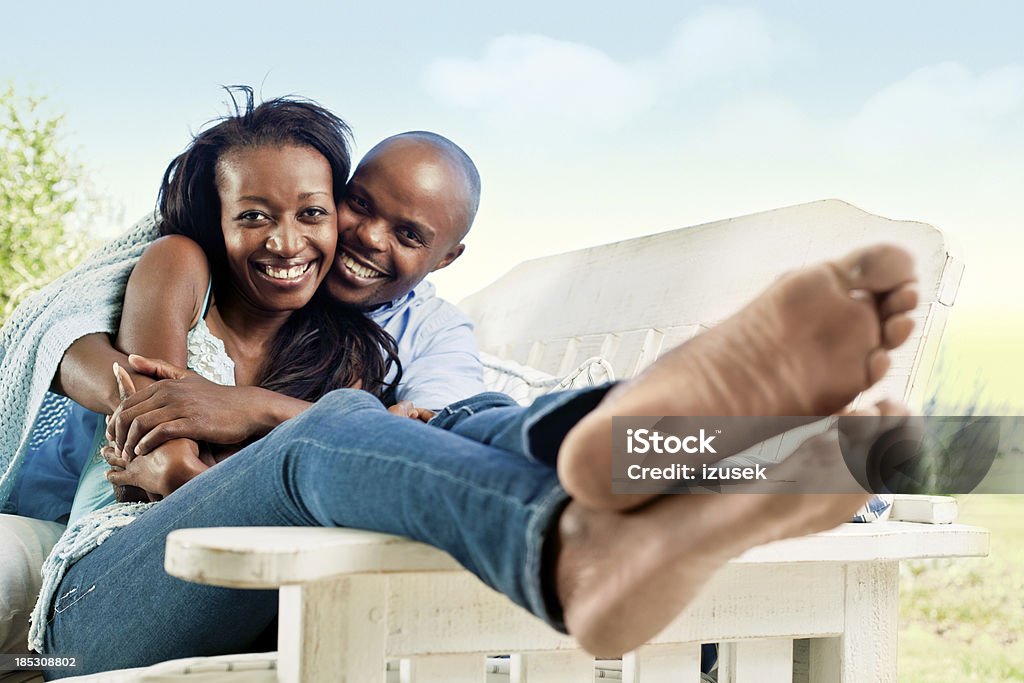 Happy couple Happy couple sitting outdoors and embracing, smiling at the camera. Beauty Stock Photo