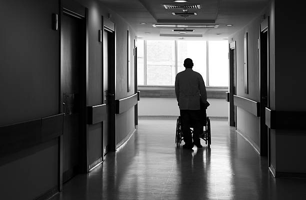 An elderly person being pushed in a wheelchair.Lightbox: Handicapped