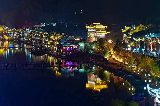 Illuminated chinese buildings and reflection the river