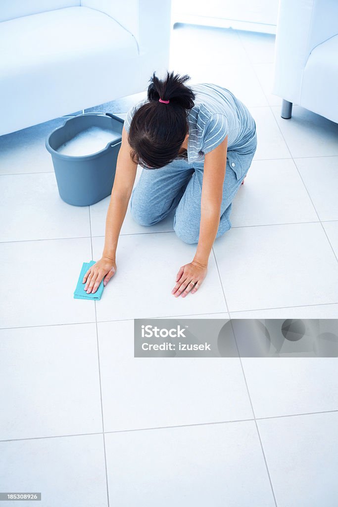 Woman cleaning floor Woman cleaning floor using cleaning rag. Activity Stock Photo