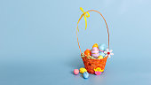 Easter wicker basket filled with decorative multi colored eggs on a light blue background