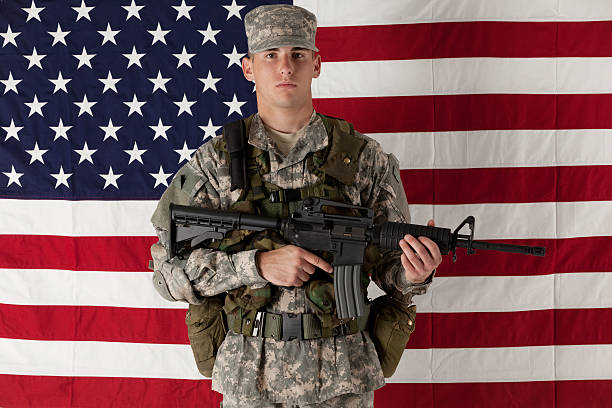 istock Army man standing in front of American flag 185309110