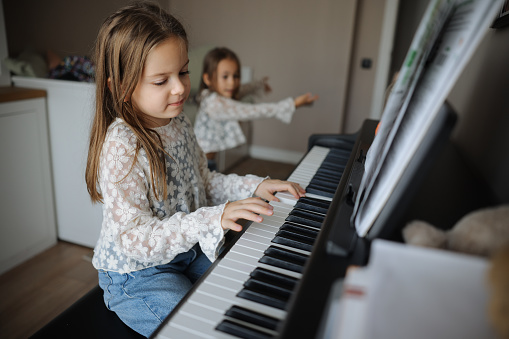 Little Girls Playing Piano Together