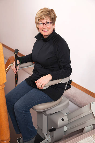 istock Mature woman using stairlift: Assisted Living 185309199