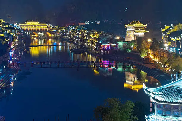 Illuminated chinese buildings and reflection the river
