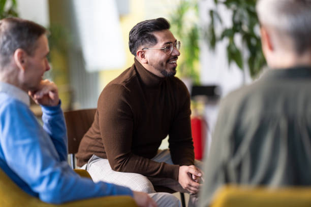 istock Young businessman smiling during team meeting at office 1853103398