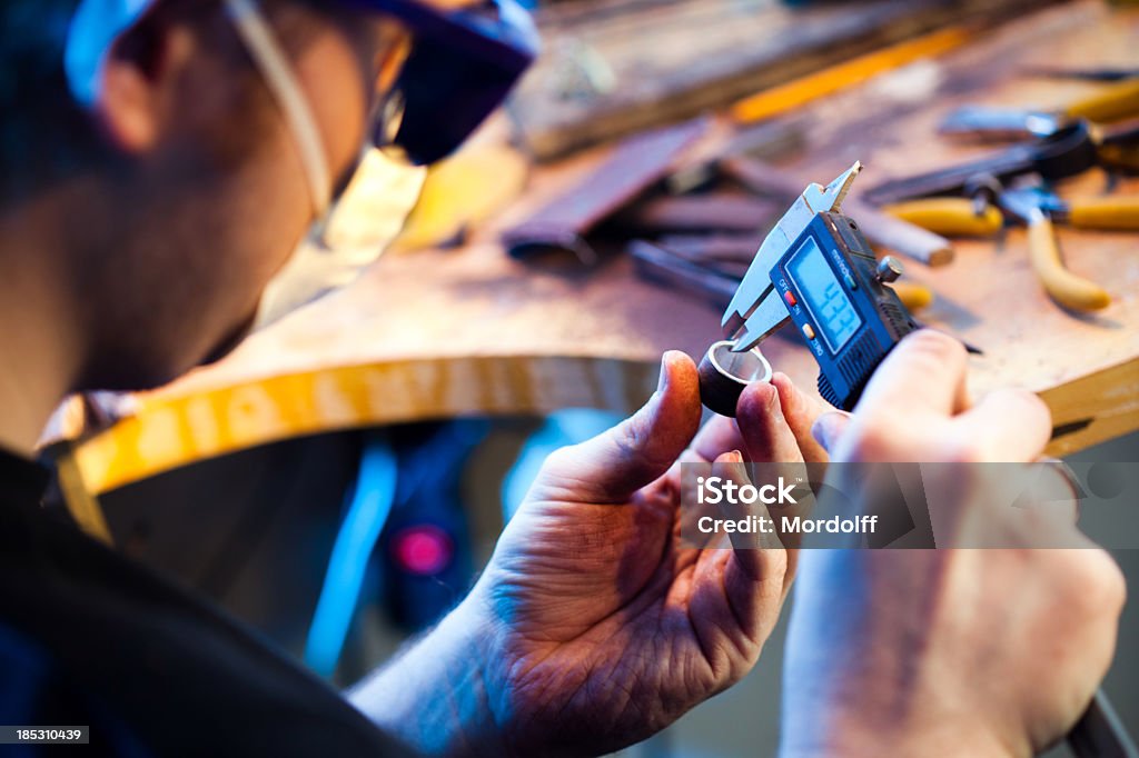Jeweller measuring a ring Jeweller measuring a ring with electronic slide gauge Caliper Stock Photo