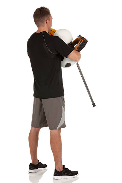 istock Man carrying sports equipment 185310644