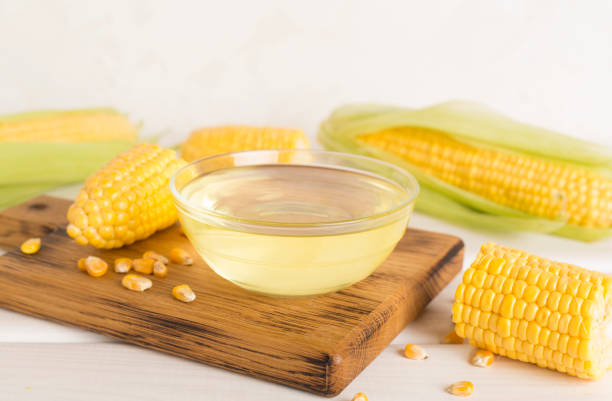 istock Corn oil with fresh cobs on wooden table 1853111109