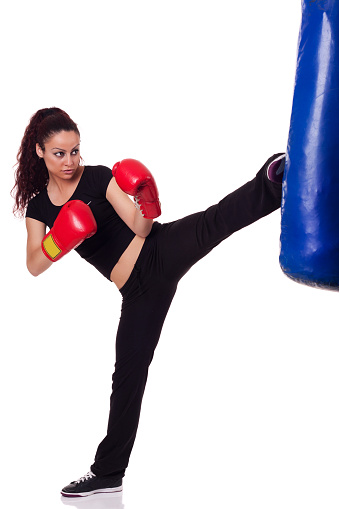 Teenage female kick boxer going through her daily training.