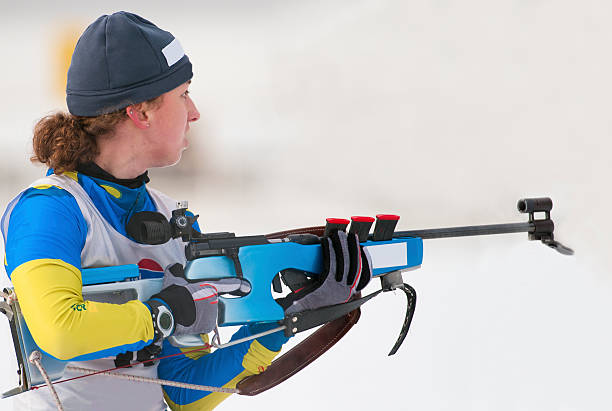 istock Female biathlon competitor preparing for target shooting 185311298