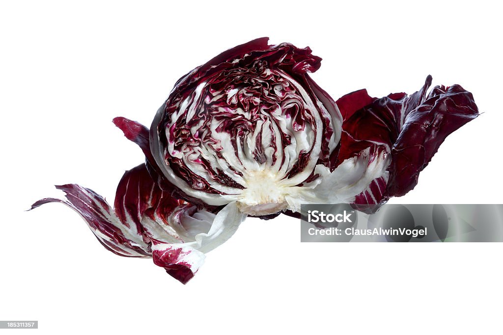 halved red cabbage or radicchio on white flying red cabbage or red endive on white background Bisected Stock Photo