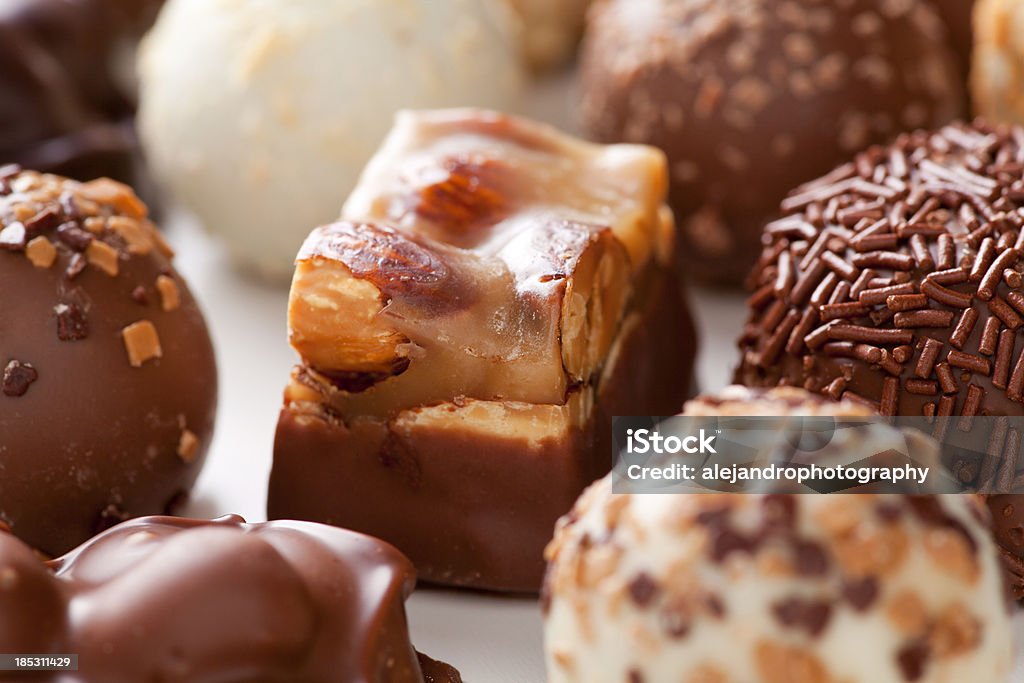 Assorted truffles "Assorted Vanilla, cream, latte macchiato, cappuccino, tiramisu, champagne, white chocolate, amaretto, raspberry, butter pecan, caramel, mousse au chocolat, and toffee grourmet truffles on white." Amaretto Liqueur Stock Photo