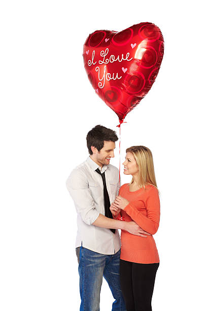 istock Attractive young man gifting red heart shaped balloon 185311454