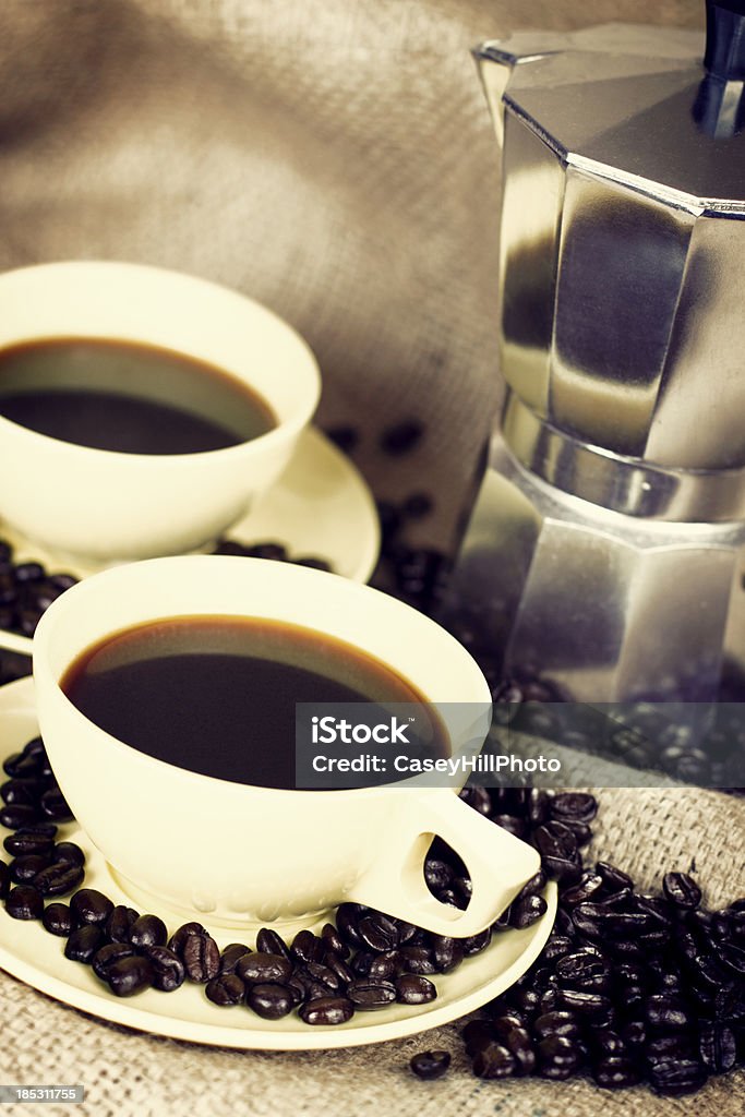 express Coffee and beans beside an espresso pot on burlap. Black Color Stock Photo