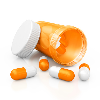 isolated open orange pill bottle and capsules.3d render.