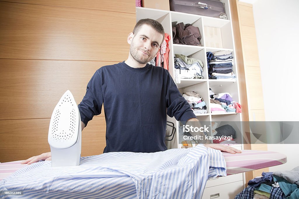 Man doing housework, ironing "Man doing ironing, smiling, posing" Adult Stock Photo