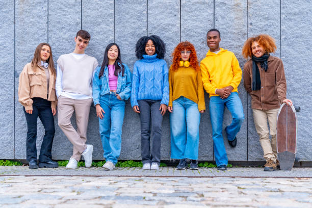 istock Multi-ethnic group of friends leaning on an urban wall 1853124097