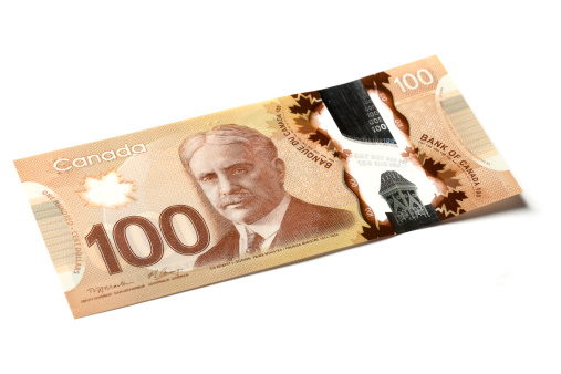A picture of the new Canadian 100 dollar bill on a white background.  The bill is made of paper and plastic.