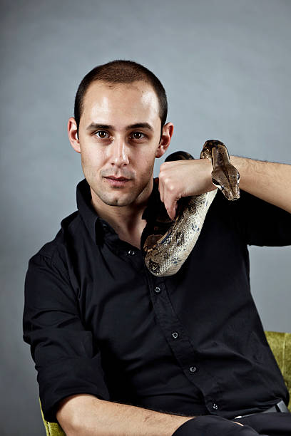 Man With Boa Constrictor Snake stock photo