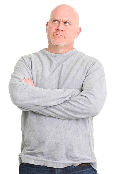 Man in sweater thinking and looking up on white background stock photo