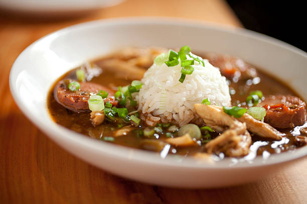 Dinner consisting of chicken gumbo with rice Close up of delicious, hearty chicken gumbo with big chunks of chicken and thick slices of andouille sausage.  finished off with a scoop of rice in the middle.   stew photos stock pictures, royalty-free photos & images