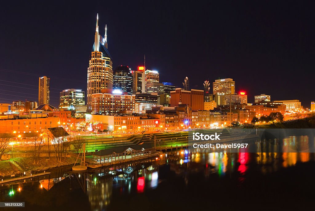 View of lit Nashville skyline at night from the water View of the Downtown Nashville skyline at night with a nice reflection on the Cumberland River below.  Nashville is known for being the center of Country Music. Nashville Stock Photo